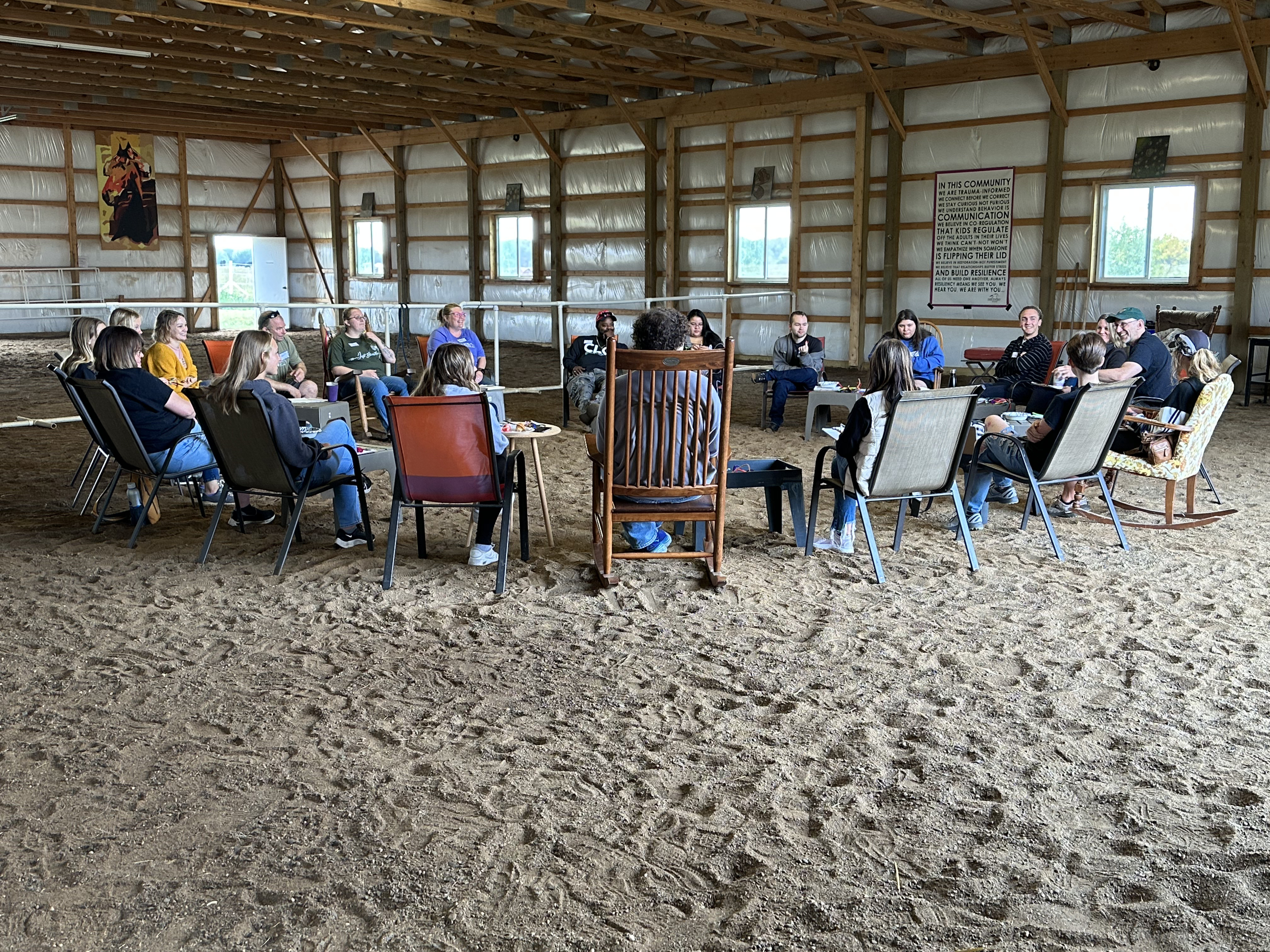 Caregivers gathered in a circle in the Dandelion arena