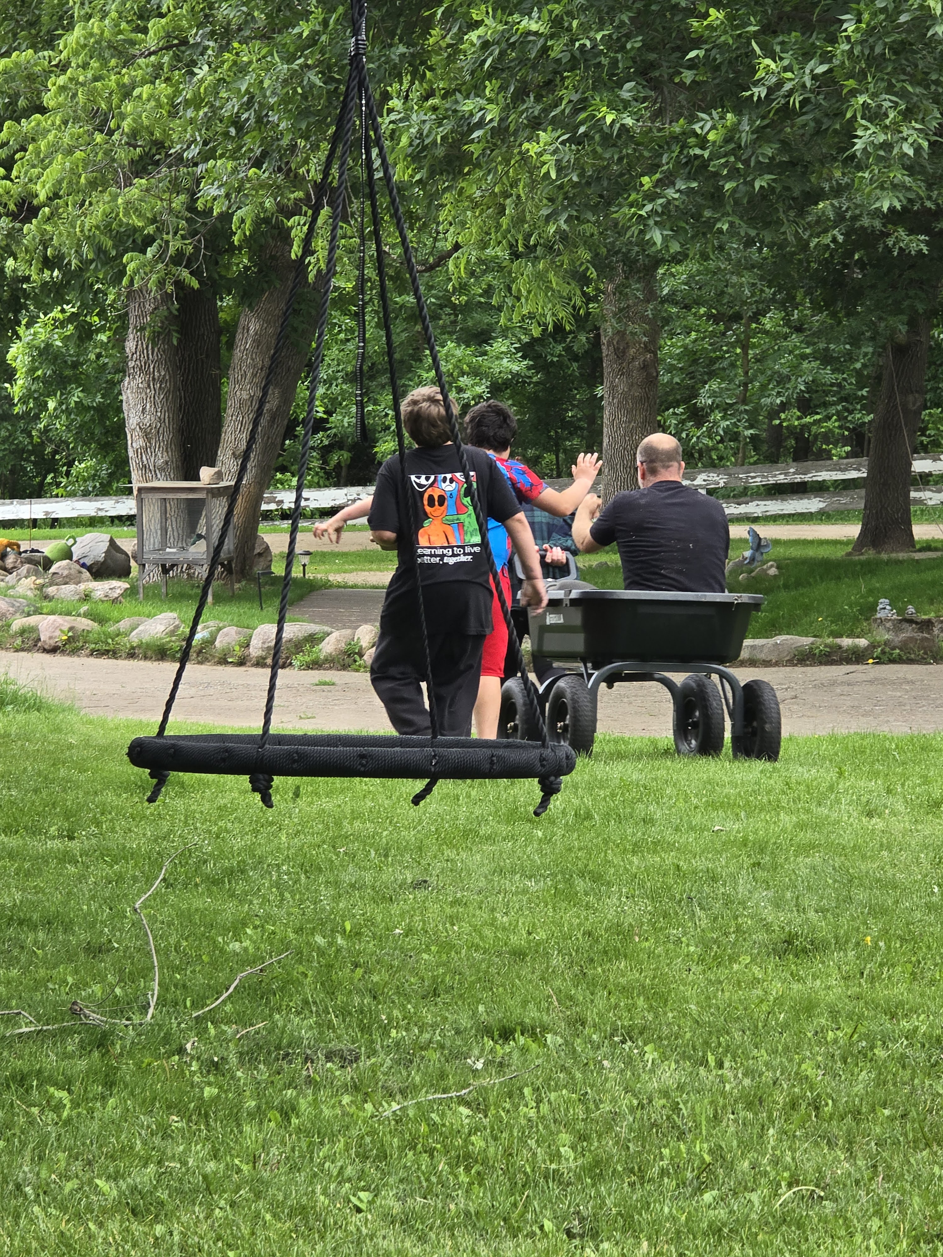 Matt spending time outdoors with two young people, photographed from behind